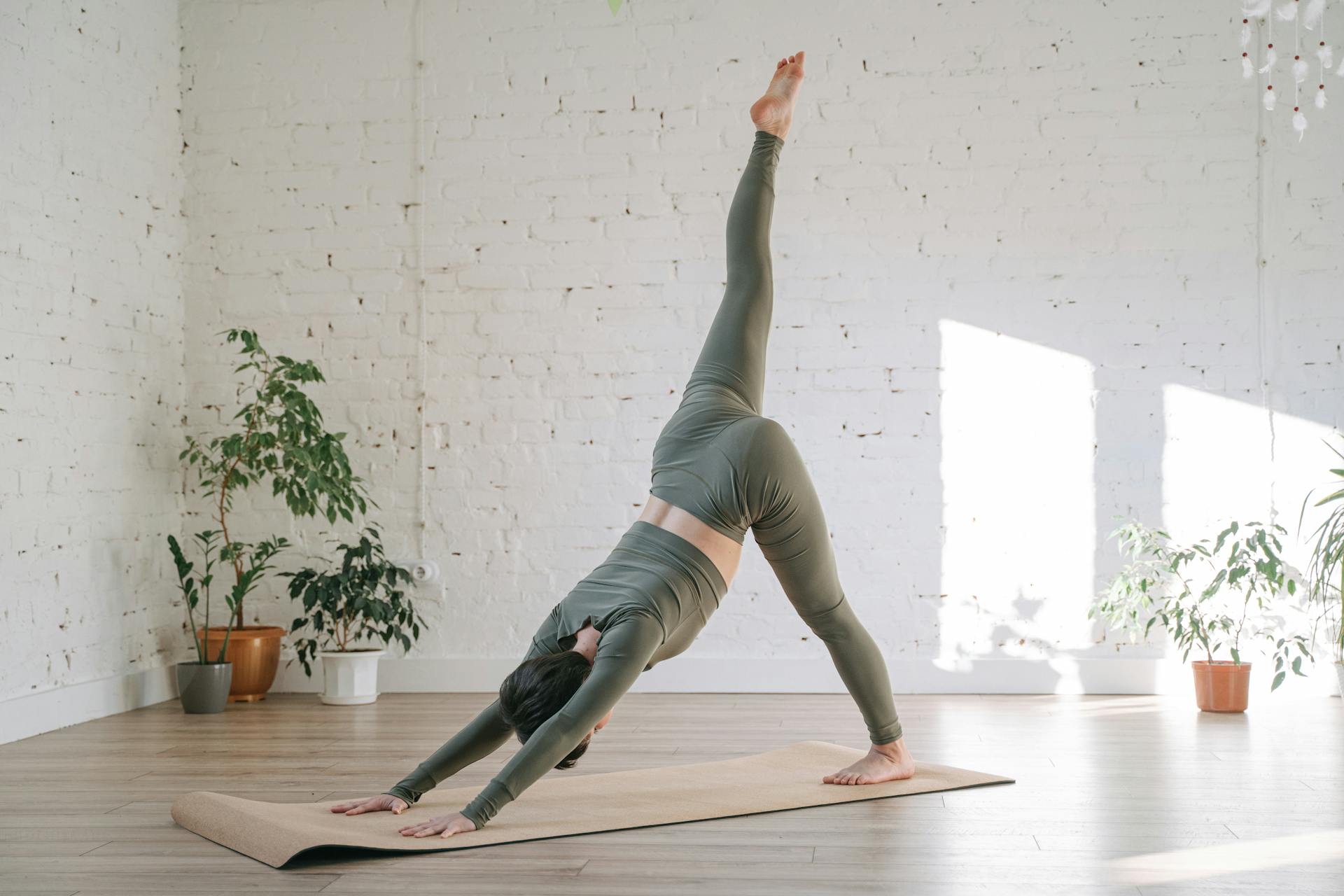 Woman practicing downward dog on cork yoga mat